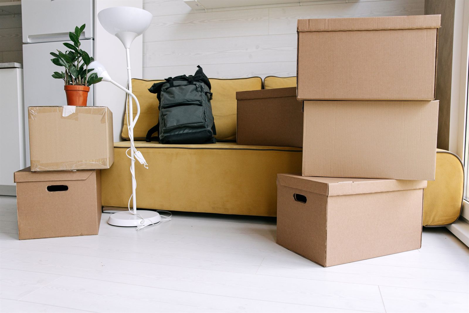 A sofa and moving boxes in a living room