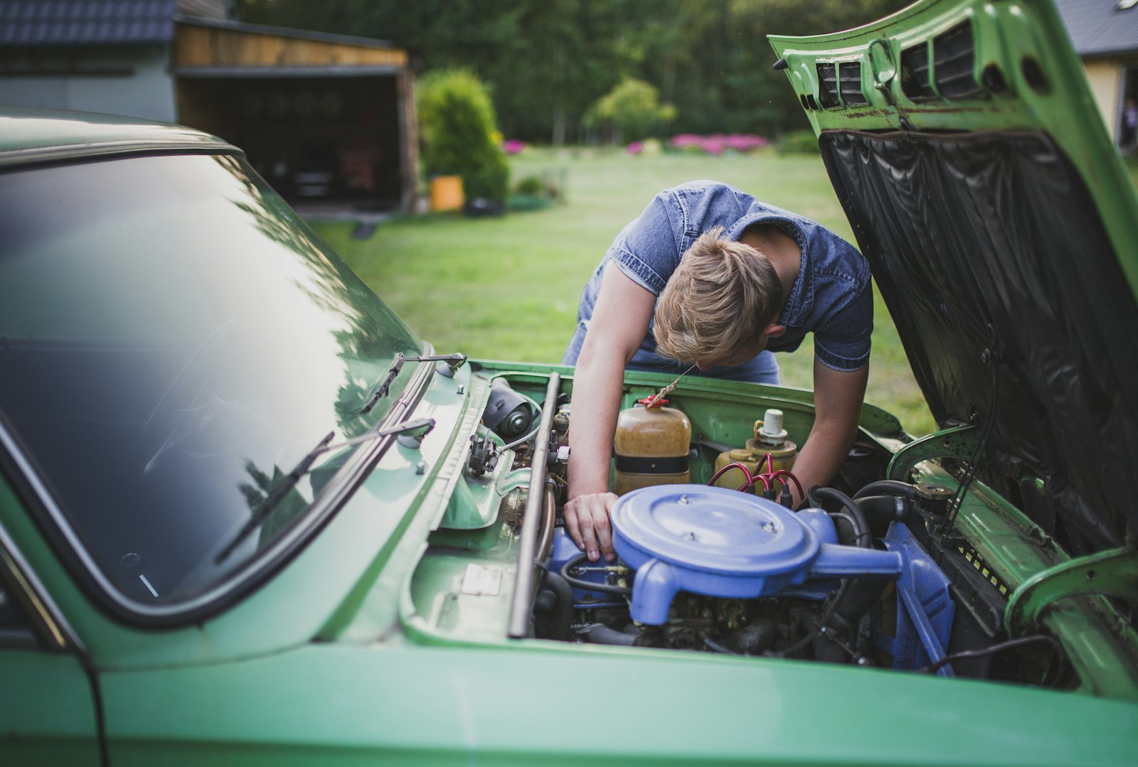 A man checking the engine of a used car