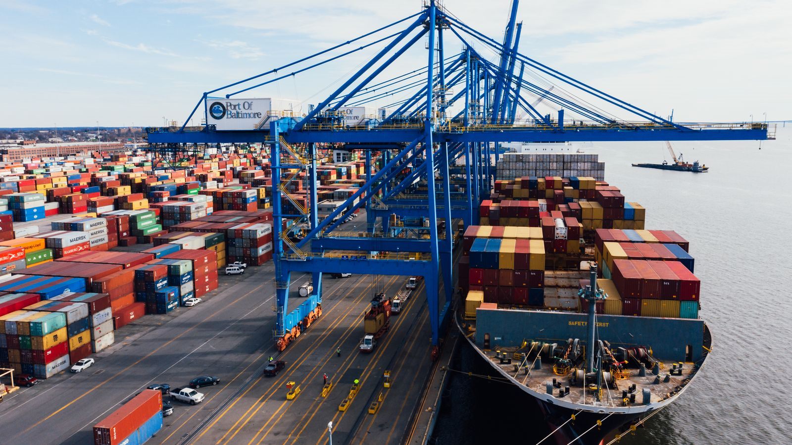Aerial view of a container ship being unloaded at a port terminal